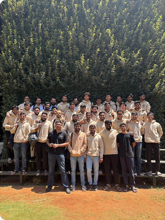 IIM Bangalore group wearing cream hoodies outdoors on campus