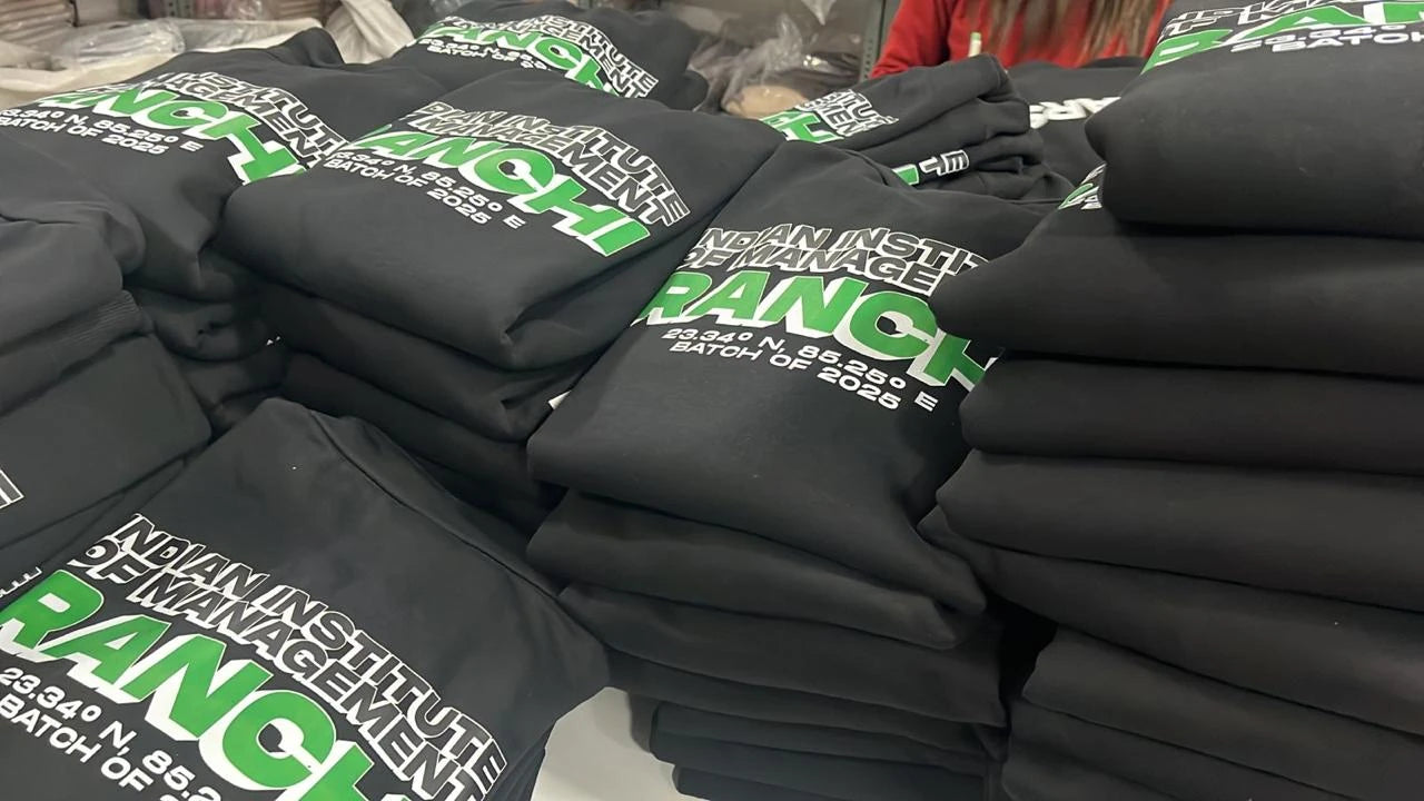 Stacks of printed IIM Ranchi batch hoodies during production